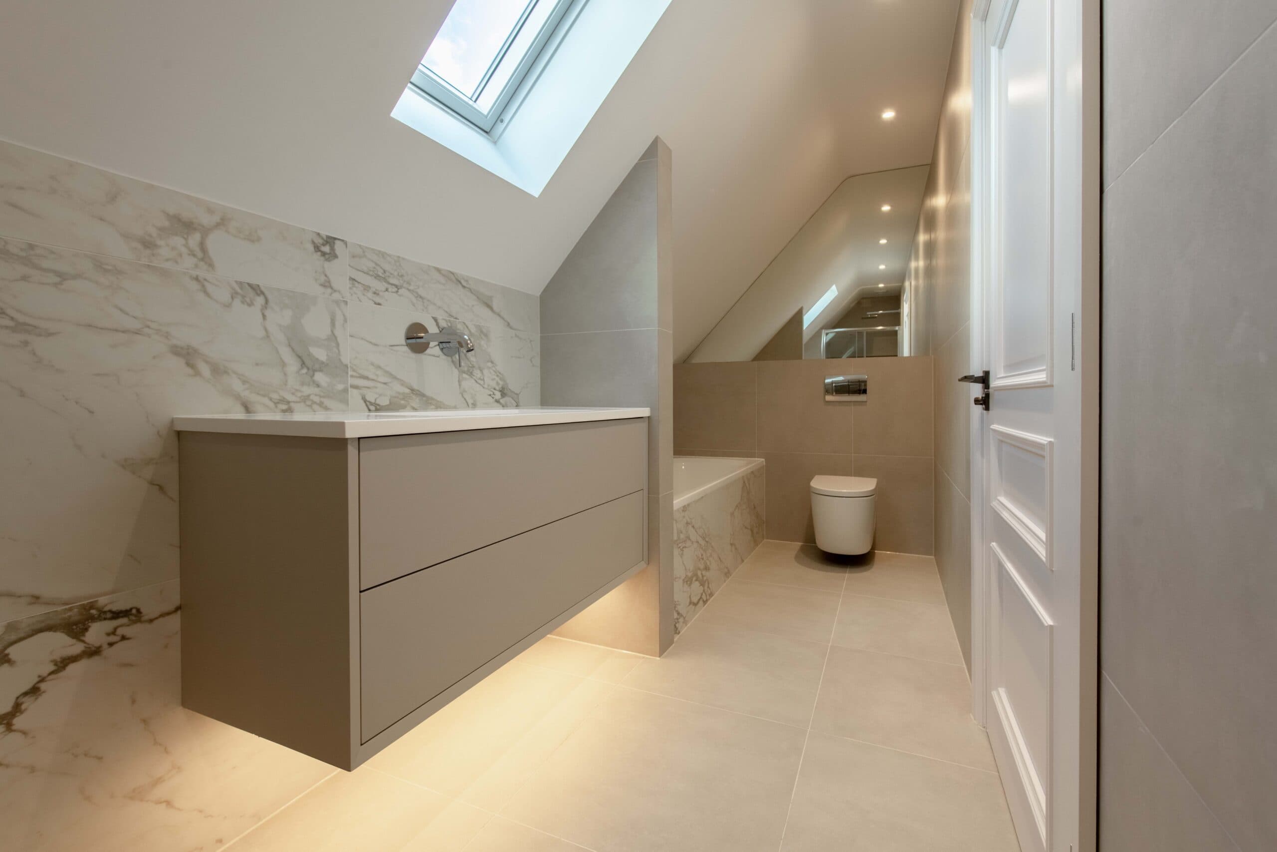 Bathroom with marble-effect walls, a floating vanity with under-lighting and a skylight
